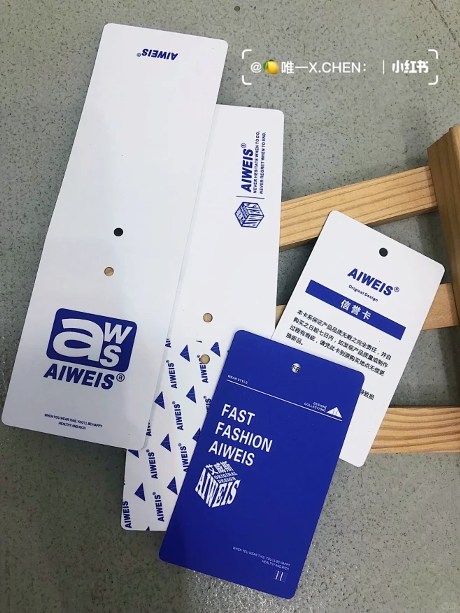 Custom hang tags and paper stock swatches displayed on a workbench