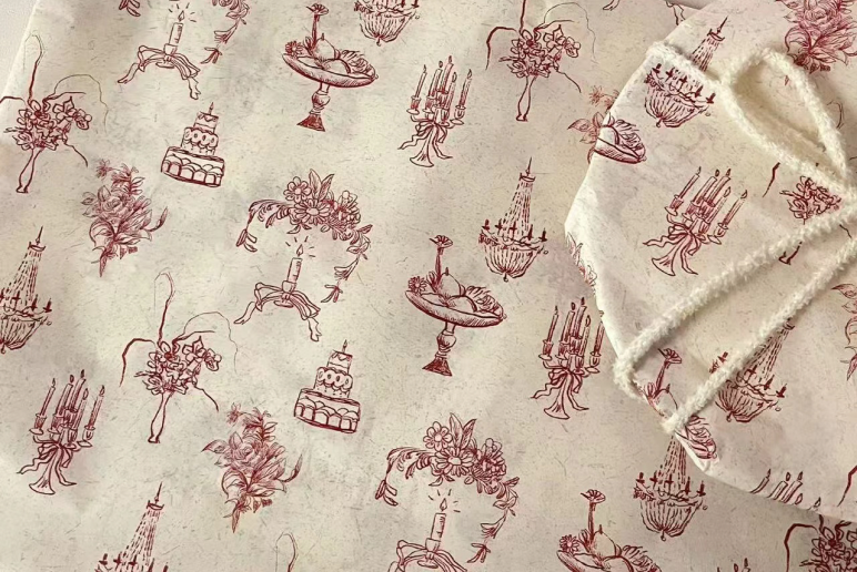 Beige tissue paper with repeating monogram print