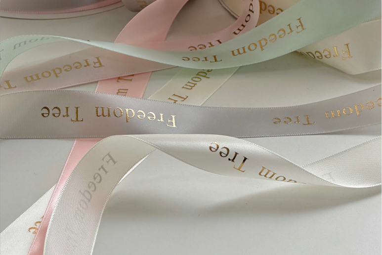 Gold foil logo printed on satin ribbon