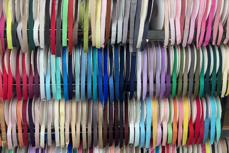 Assorted ribbon rolls displayed on shelves
