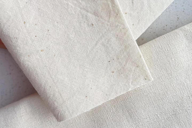 Natural unbleached cotton fabric for custom dust bags and branded drawstring pouches