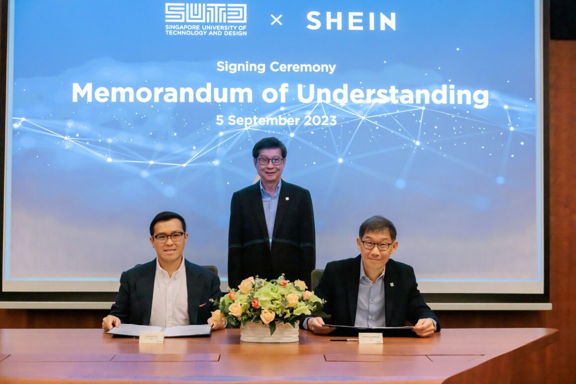 Three people at a table during a signing ceremony between SUTD and SHEIN