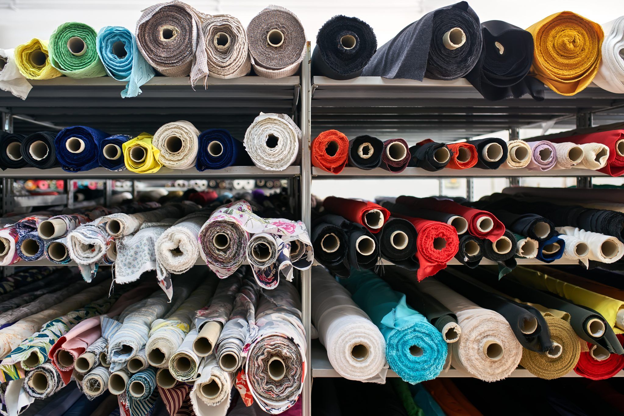Colorful fabric rolls on shelves in a textile store