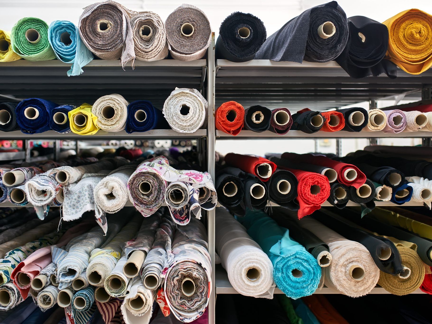 Colorful fabric rolls on shelves in a textile store