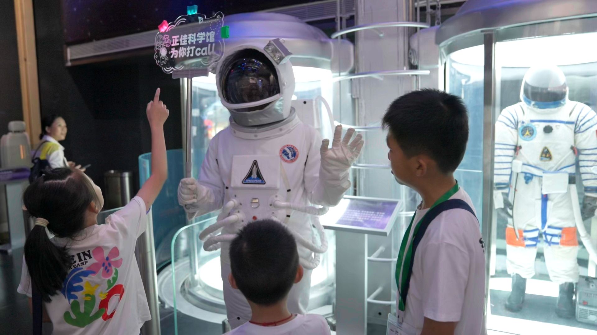 An astronaut and three children