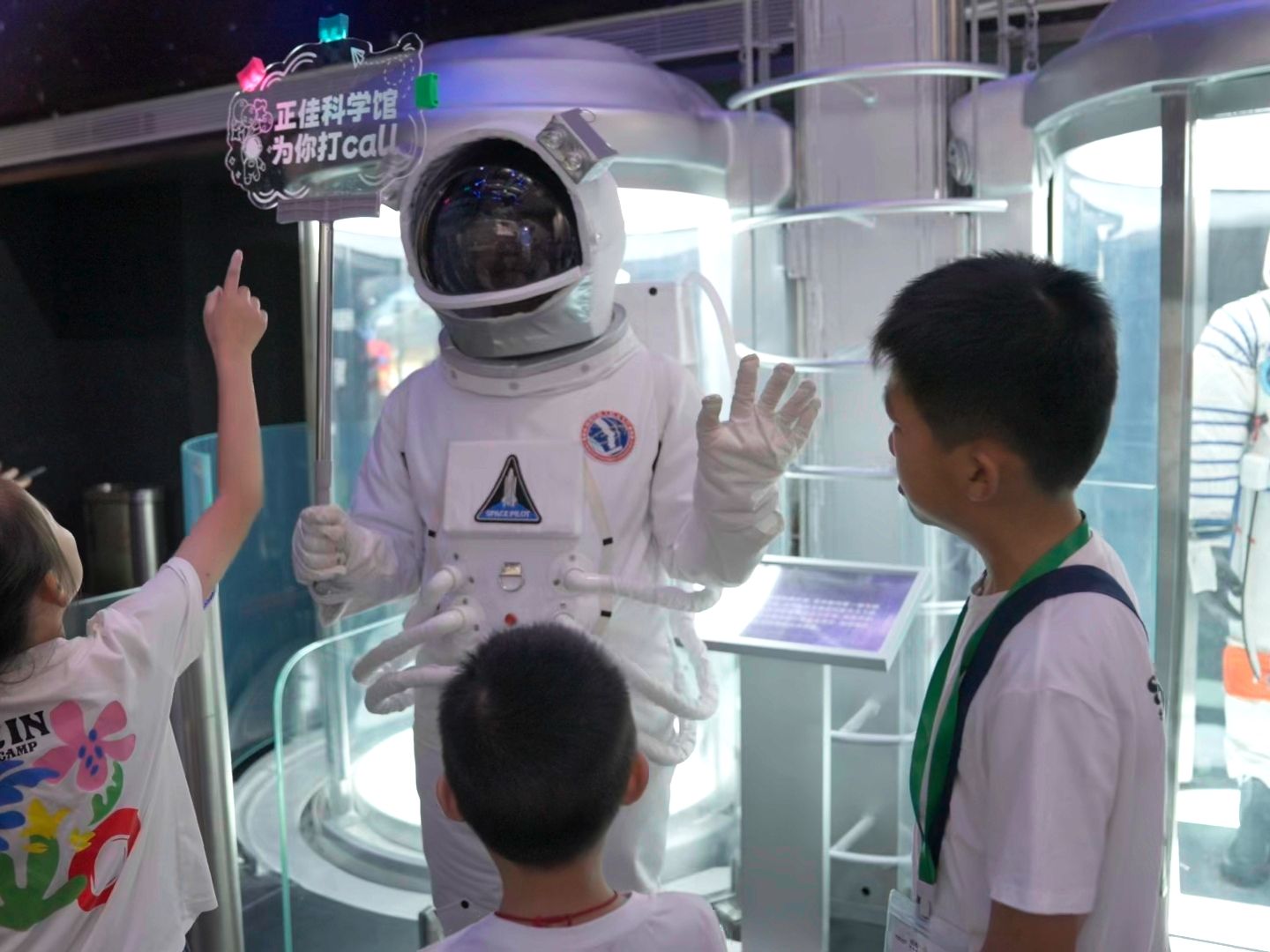 An astronaut and three children