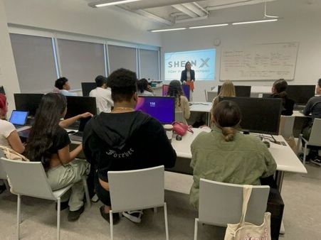 Students in a classroom watching a presentation about SHEIN X