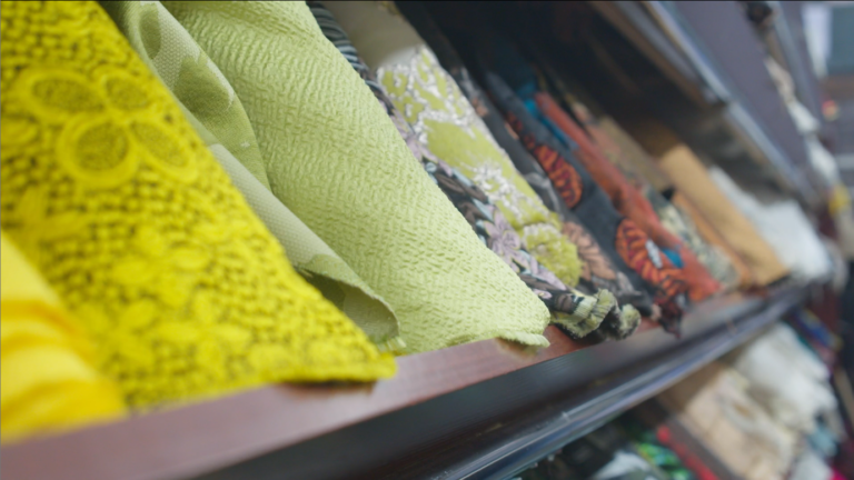 Rolls of fabrics on a shelf