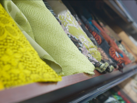 Rolls of fabrics on a shelf
