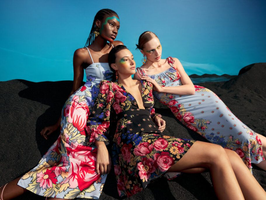 Three models posing in different dresses