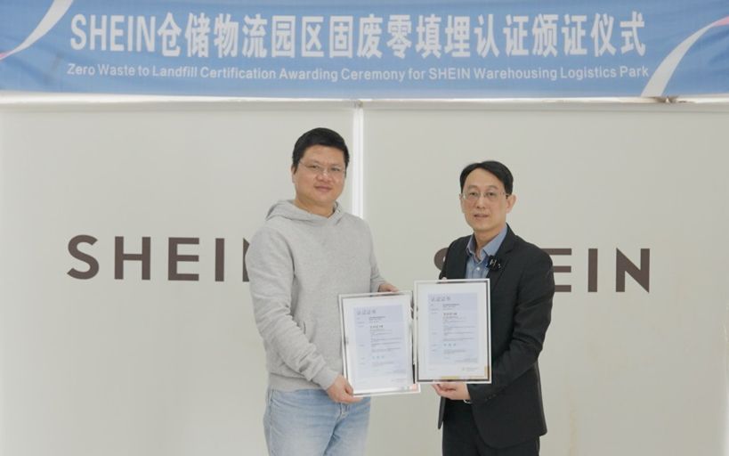 Two people standing together and holding certificates