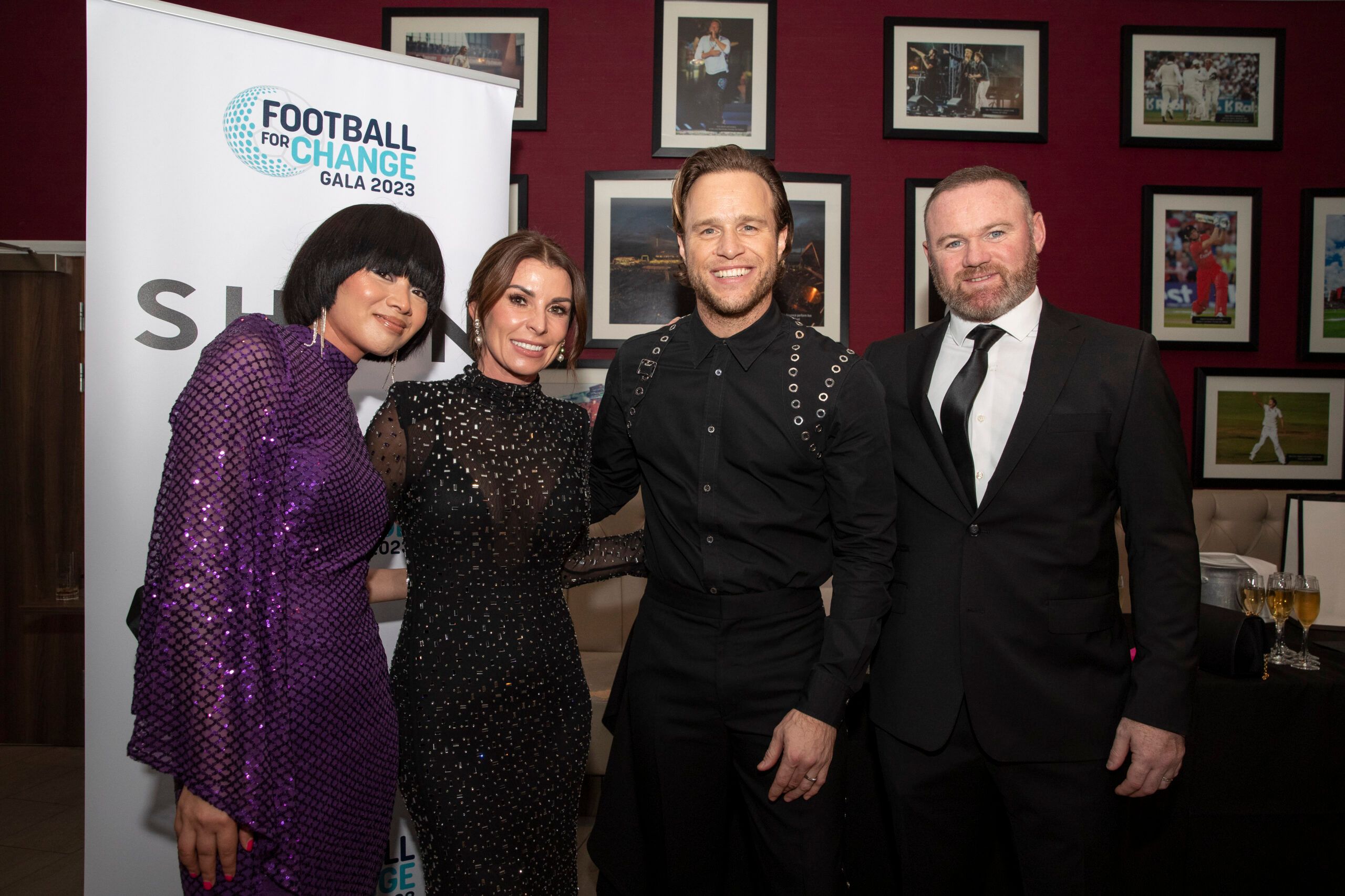 Four people dressed formally and posing together