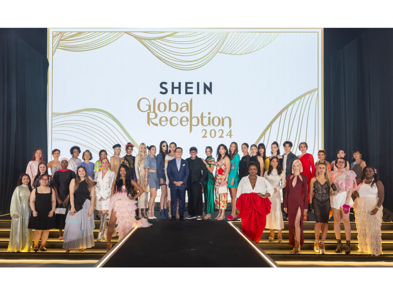 A group of people posing in front of a screen