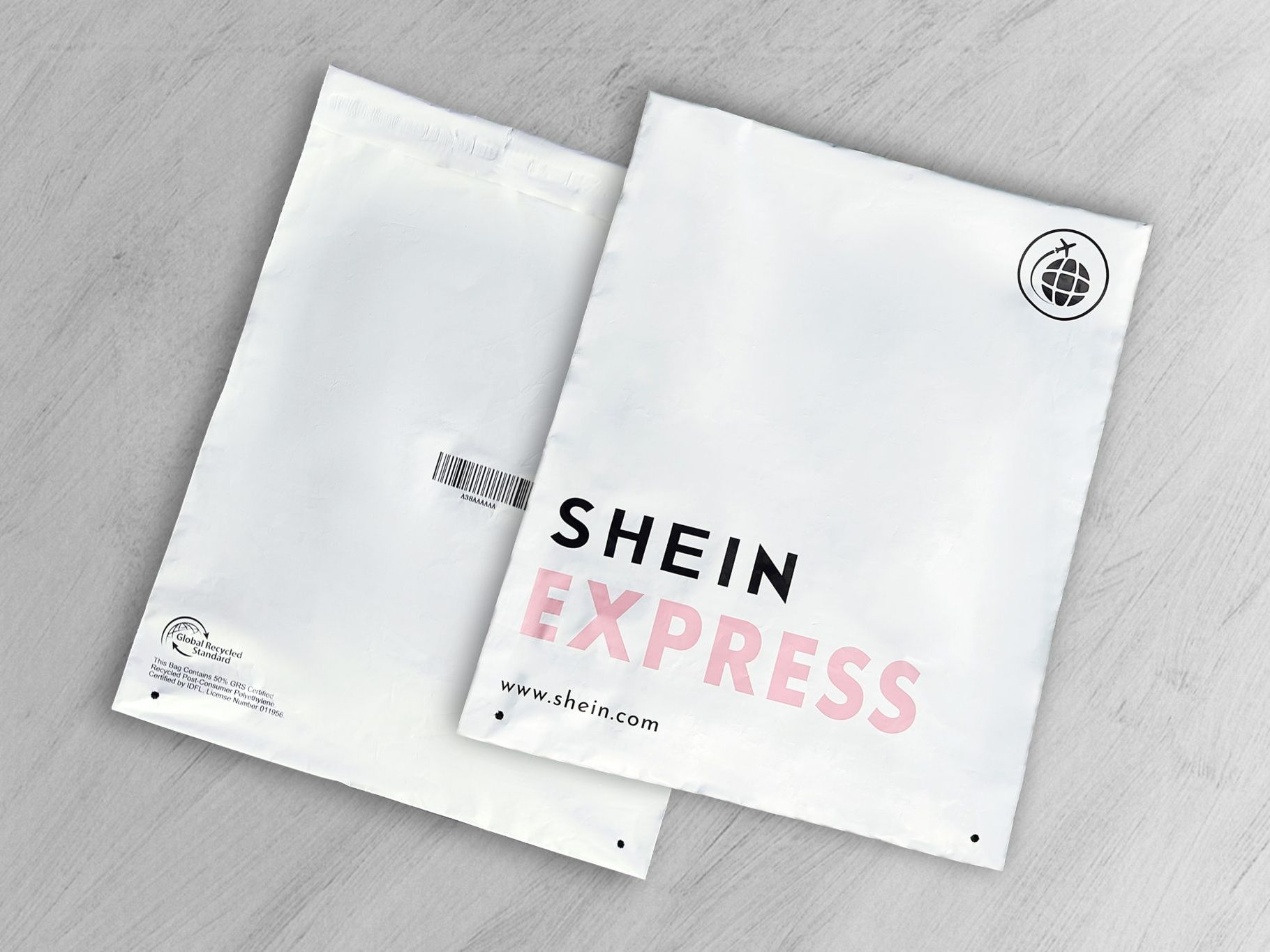Two SHEIN Express shipping bags featuring branding and a recycled materials certification