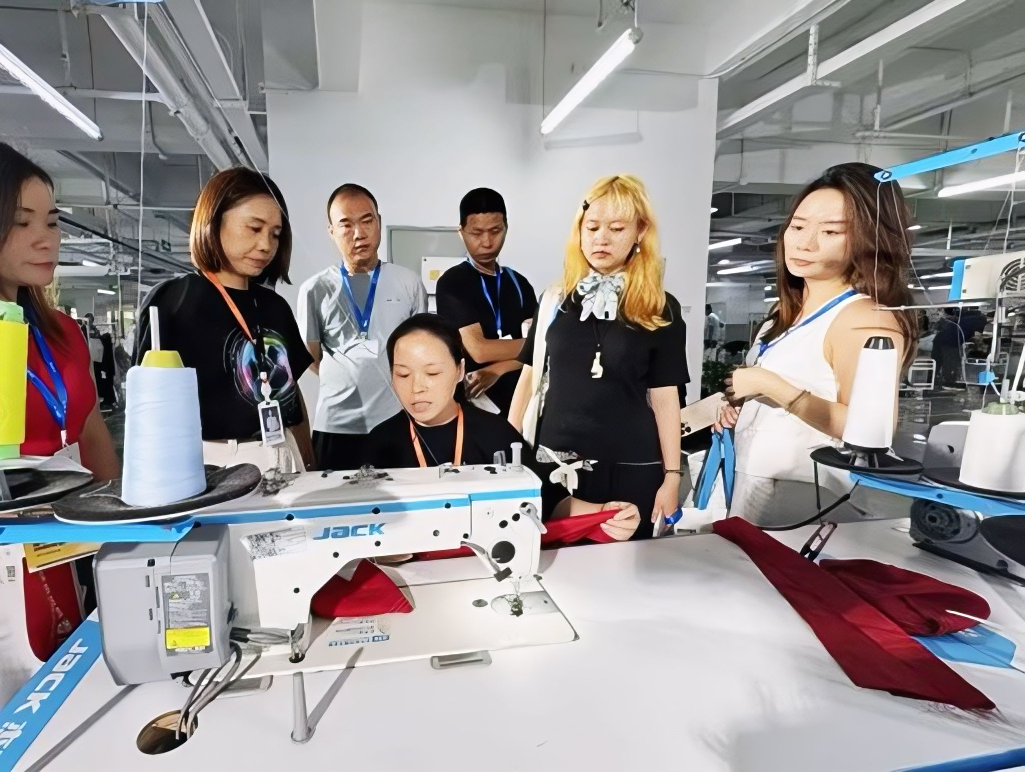 A group of people gathering around a table to look at a machine