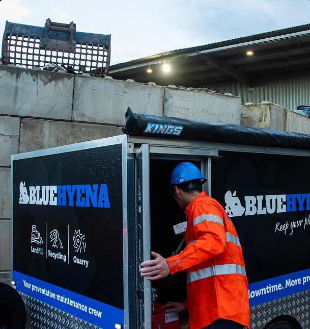 Blue Hyena crew member at the branded maintenance trailer