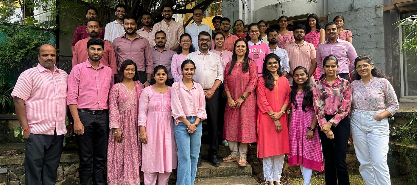 Colleagues celebrating together in pink clothing