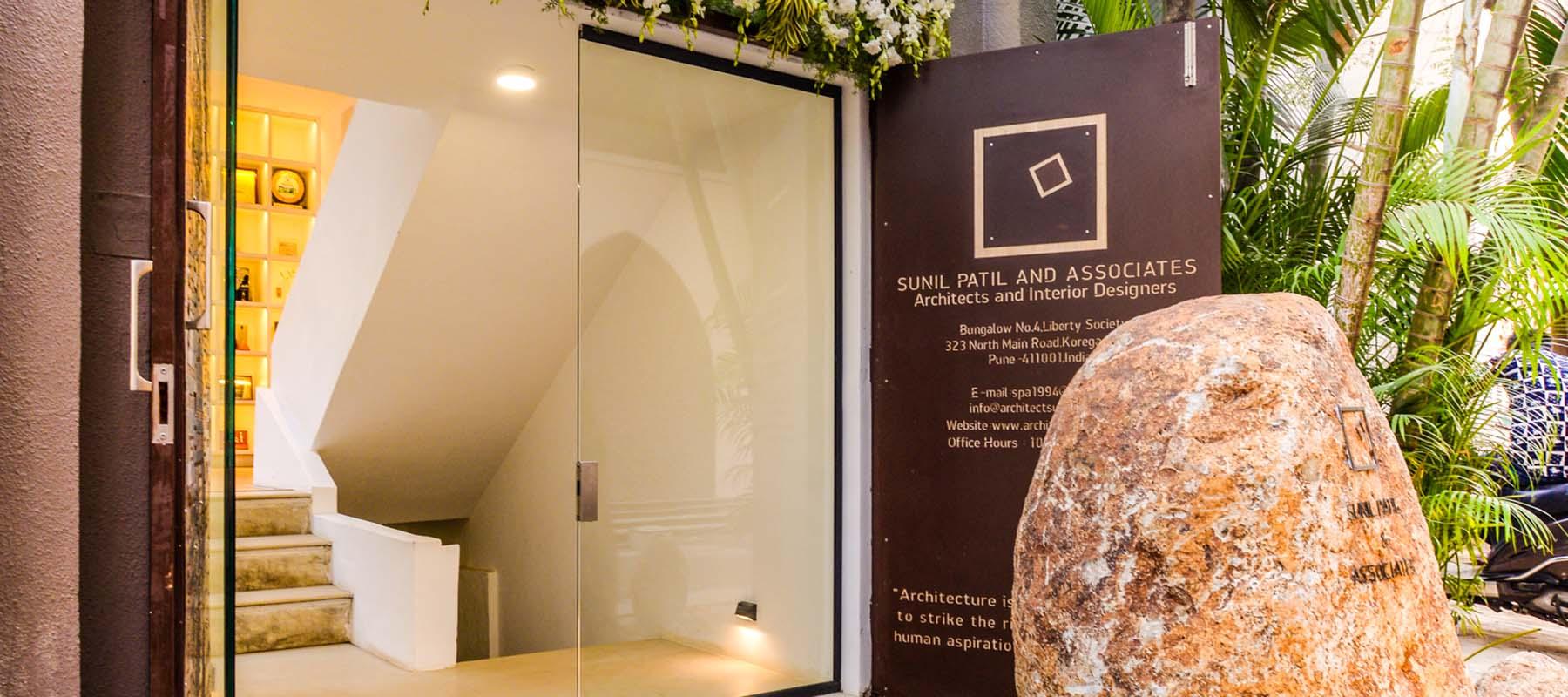 Entrance to the Sunil Patil Associates studio framed by planting and stone