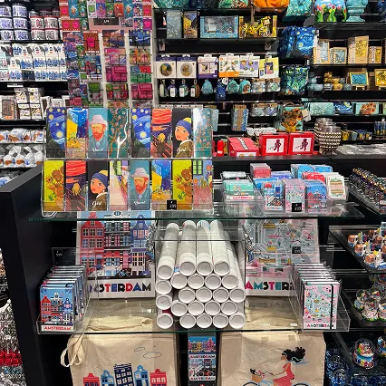 Orange Panda bookmarks and Amsterdam souvenirs in a crowded gift shop