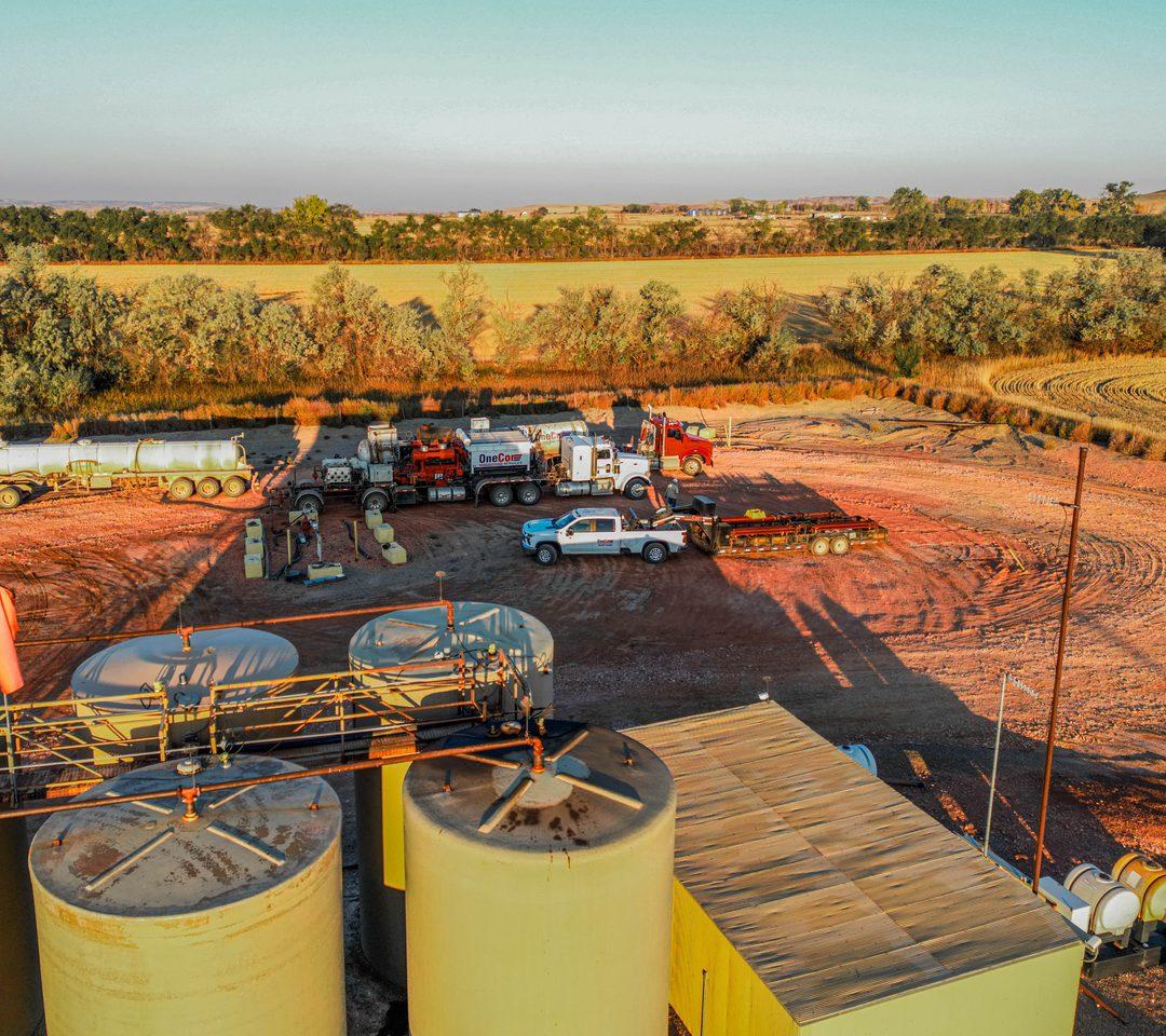OneCor pump truck, transport, and pickup on a wellsite, seen from above