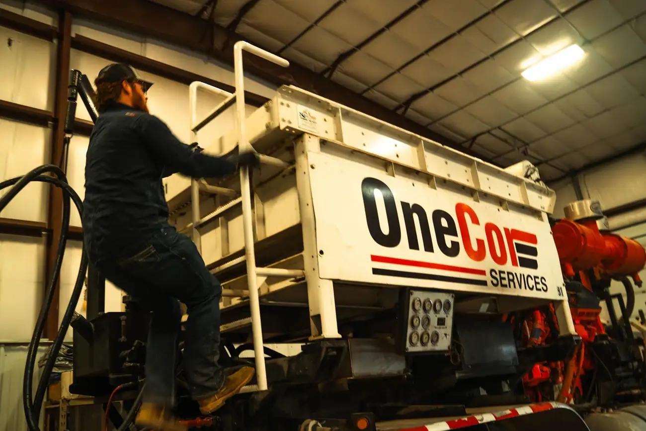 OneCor mechanic working on a pump unit in the shop