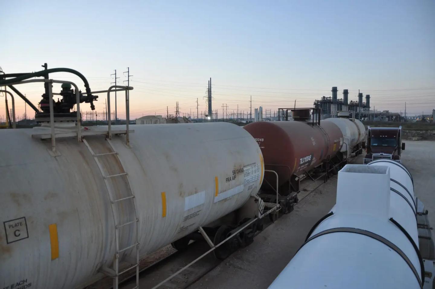 Railcars beside a OneCor tanker trailer at a Texas terminal