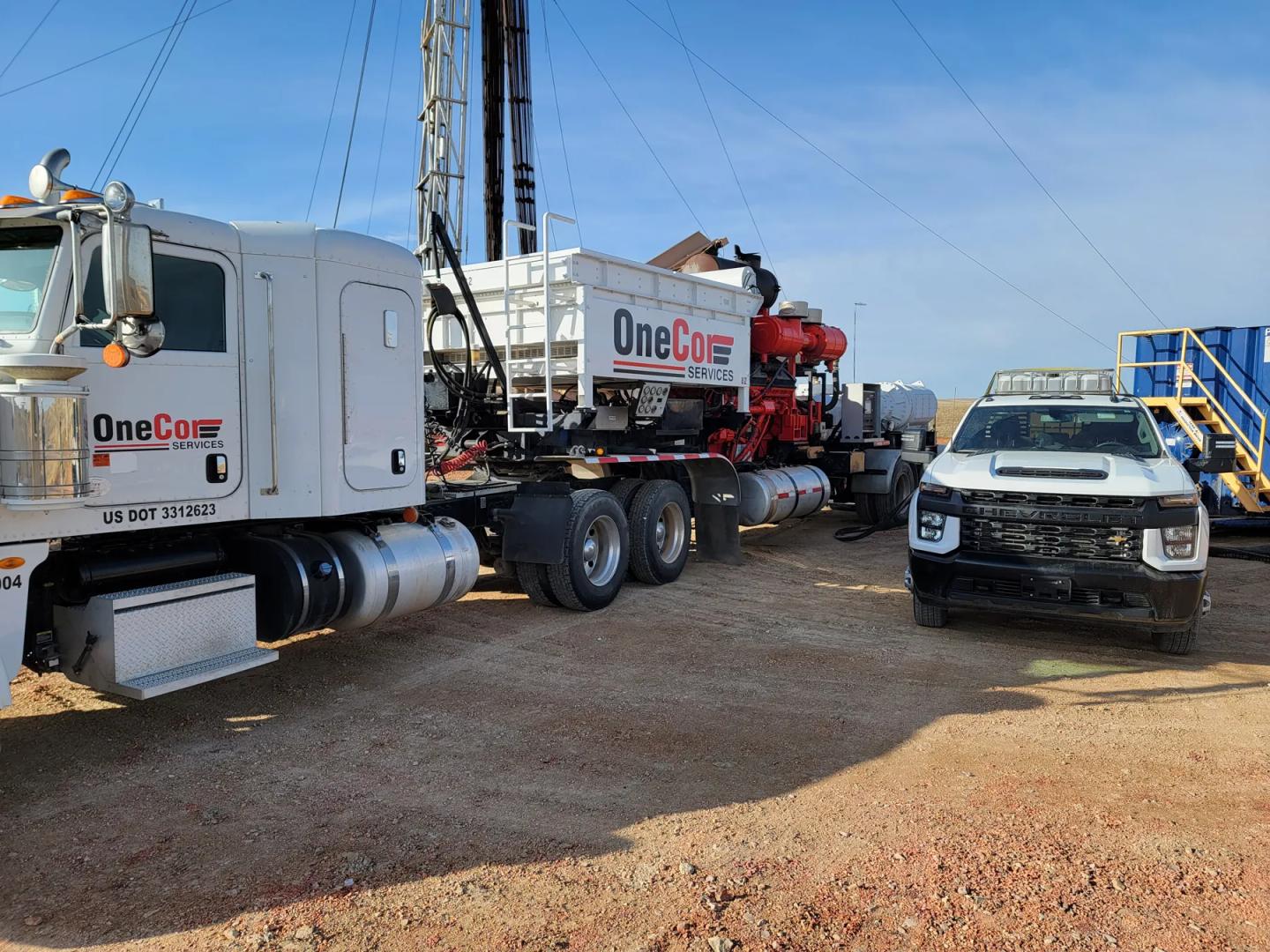 OneCor pump truck and pickup on a Bakken well location