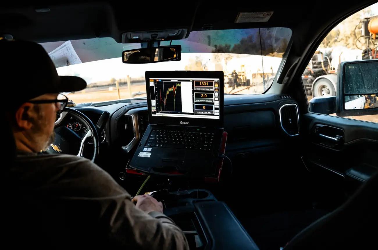 OneCor field specialist monitoring pump data from the truck