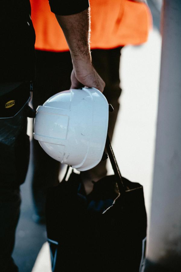 person carrying a hard hat
