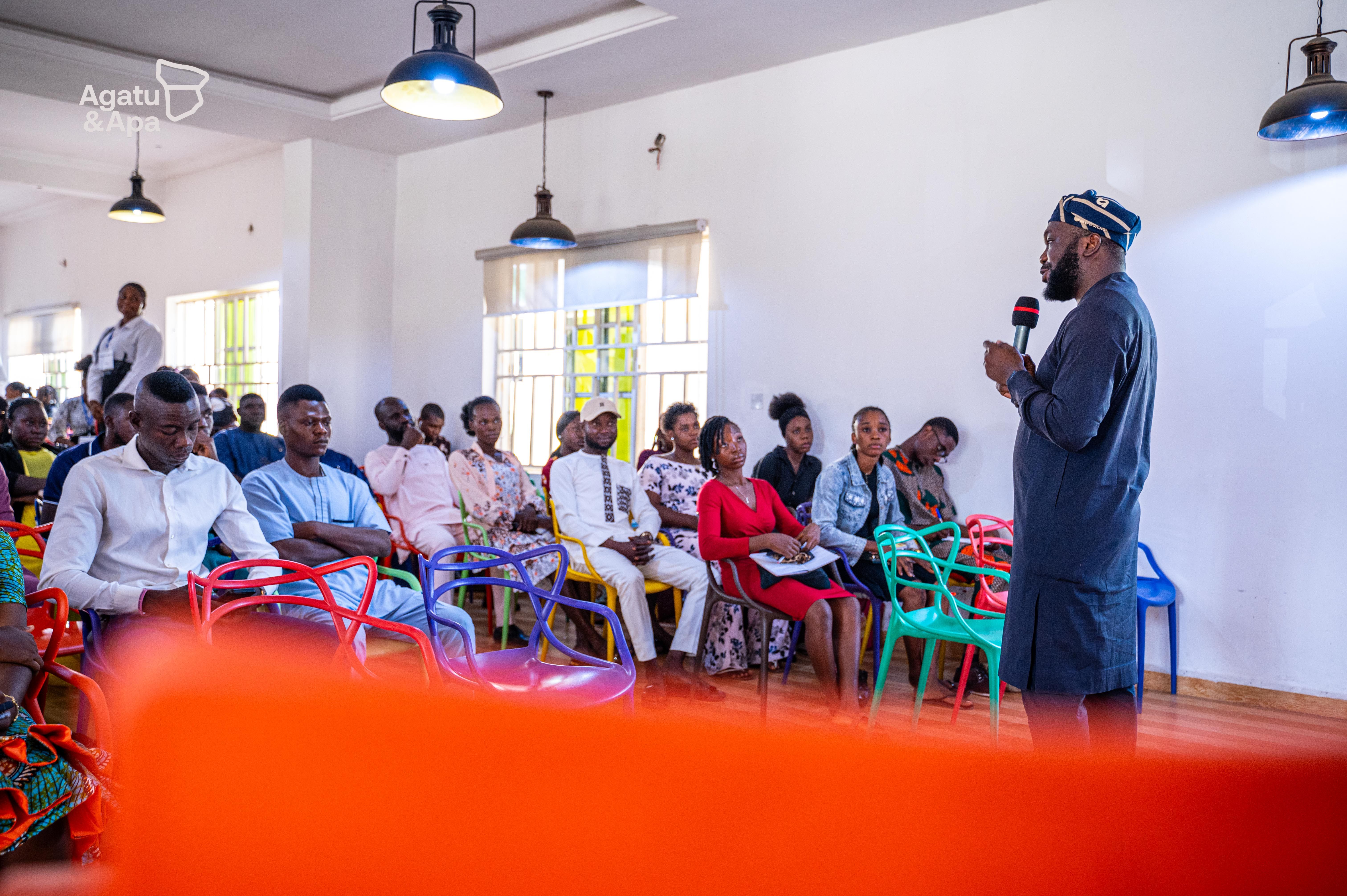 Participants listening attentively as the speaker engages the room.