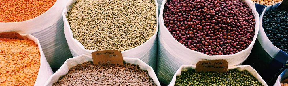 Large white bags of different kinds of beans