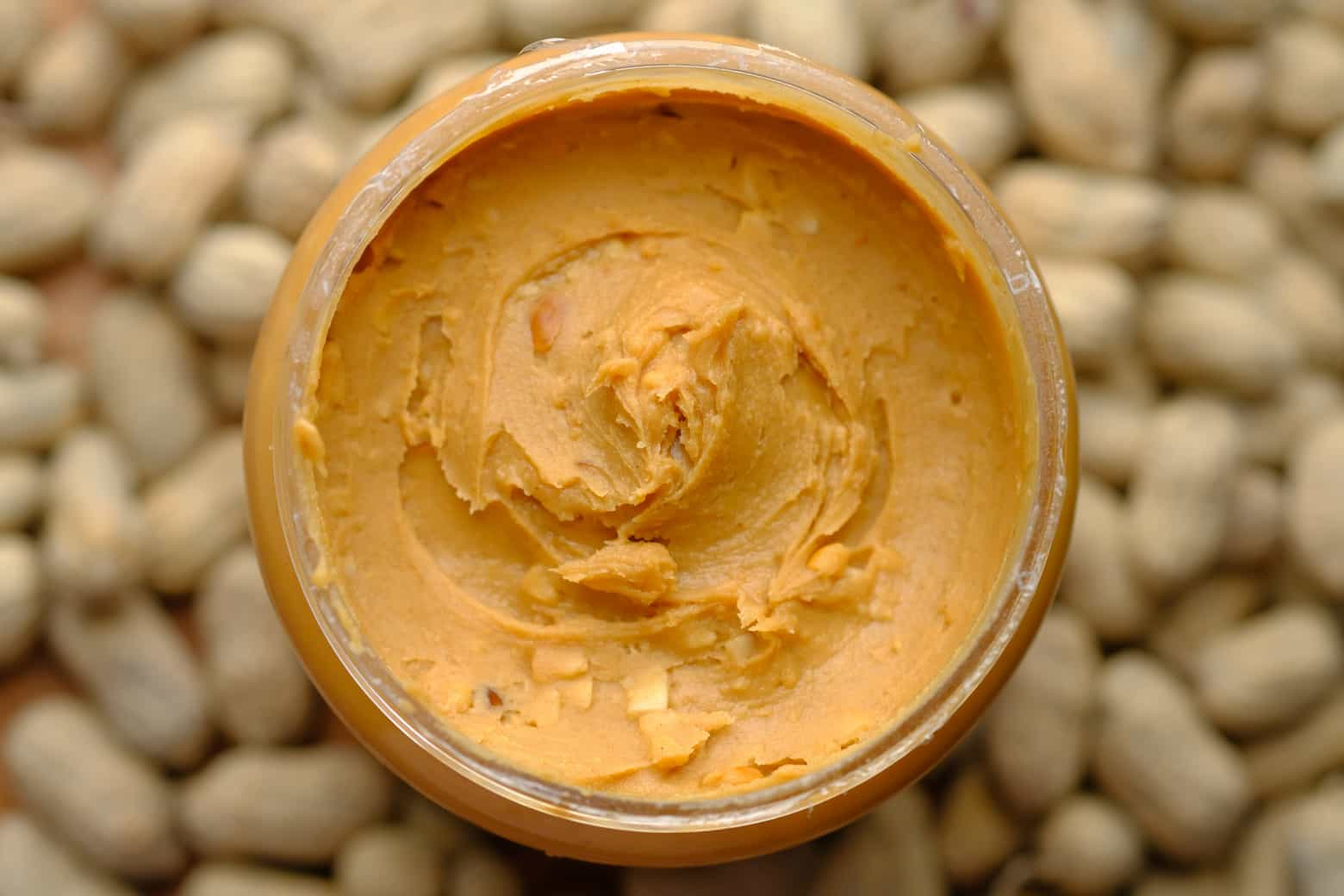 An open jar of peanut butter from above.