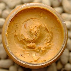 An open jar of peanut butter from above.