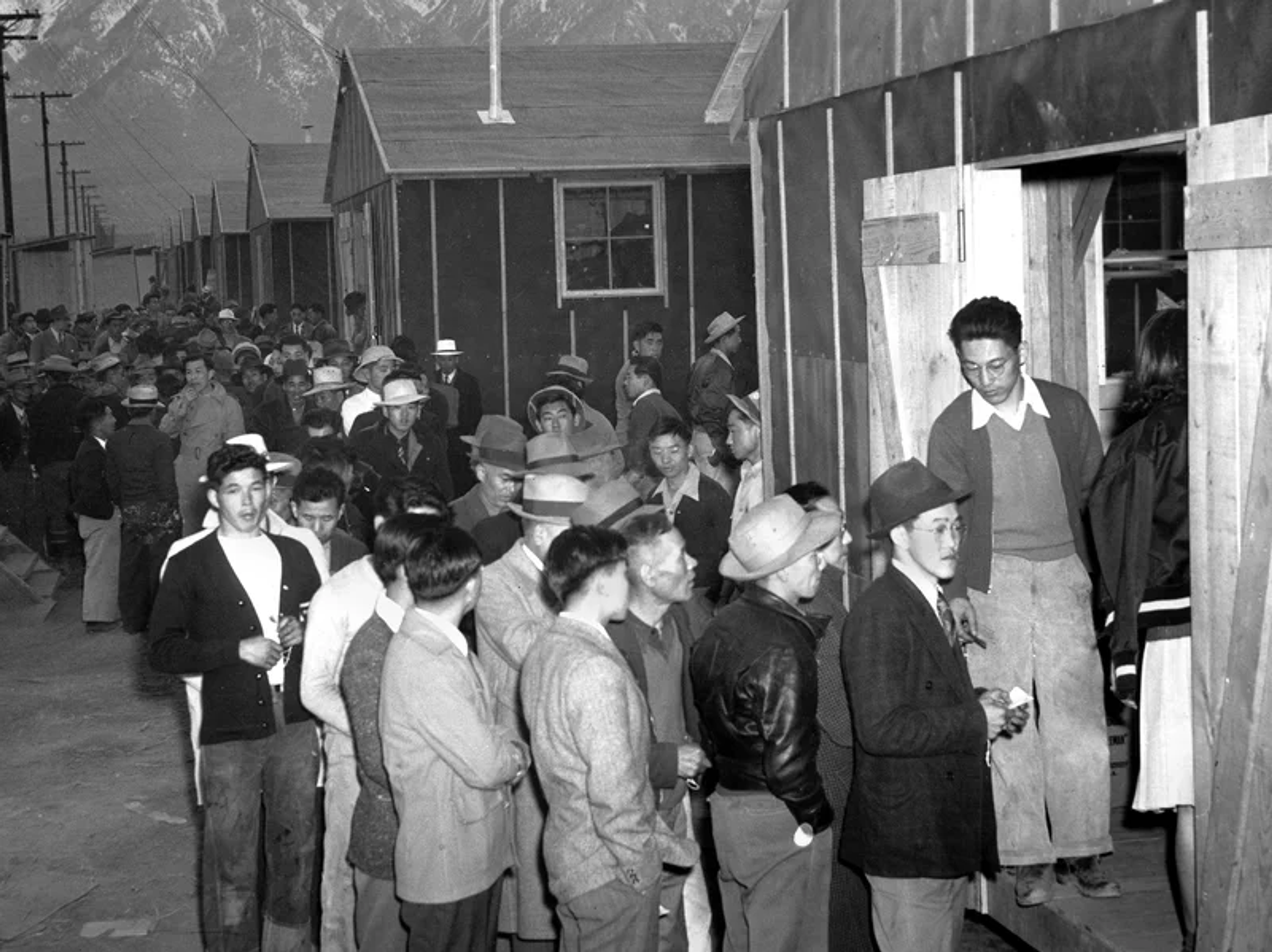 People wait in line for their housing assignment at the Manzanar internment camp in the California desert in 1942. More than 110,000 people of Japanese ancestry were removed from their homes and placed in camps in several states during World War II.