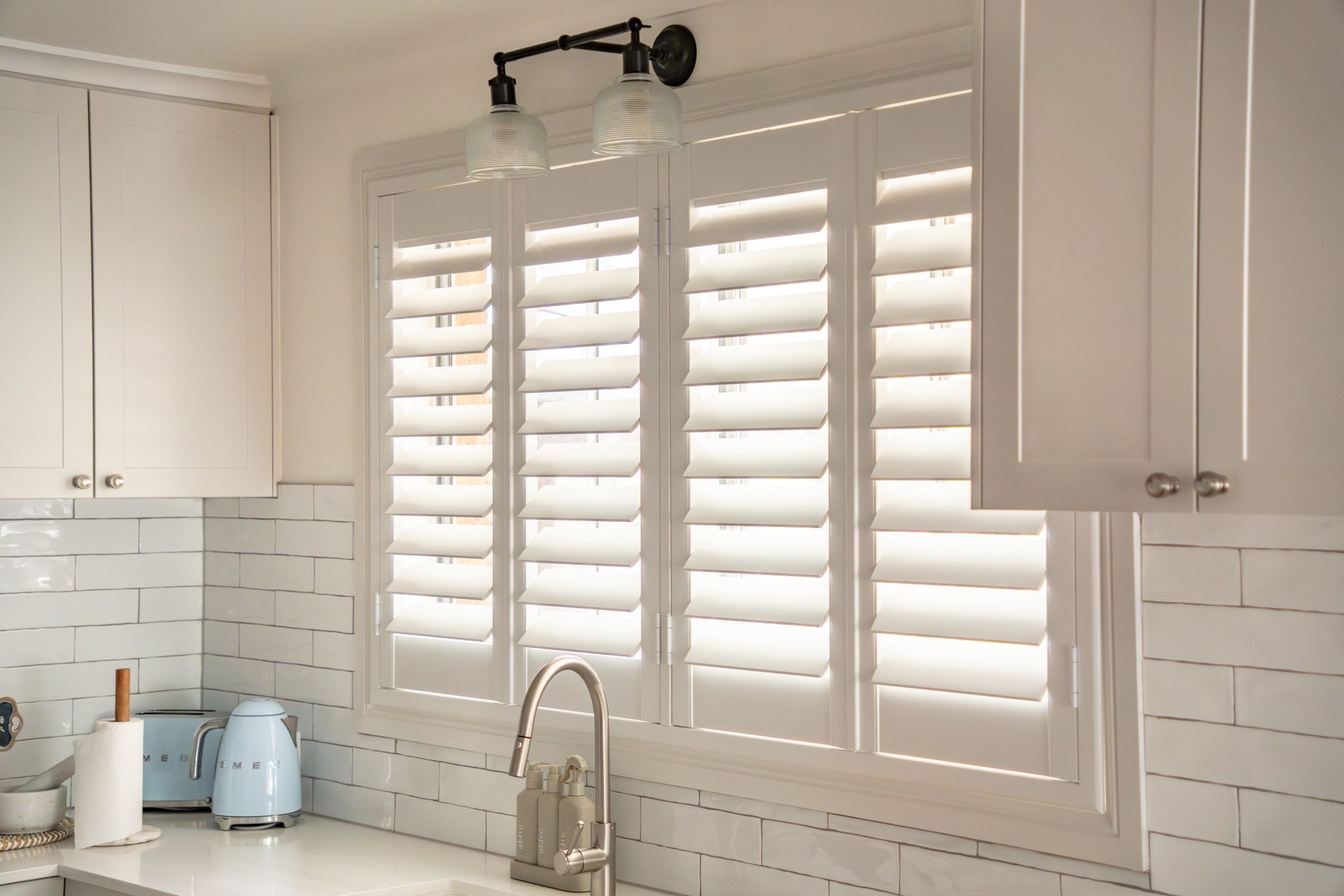 Frames matched to the existing architraves, so the shutters read as part of the building.