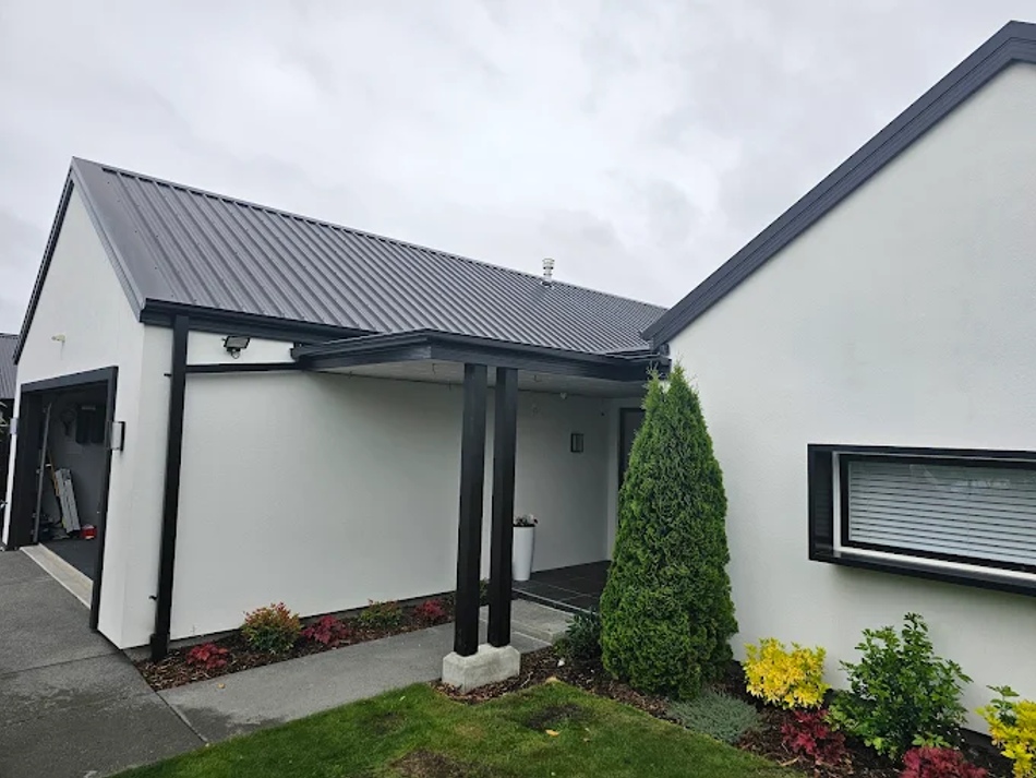 Clean black spouting and downpipes installed to complement this modern home’s exterior.