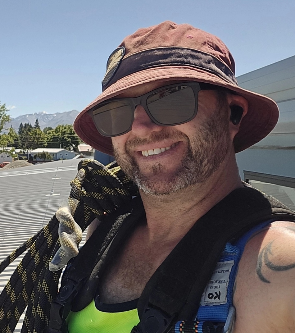 Kyle installing new spouting on a Christchurch home.