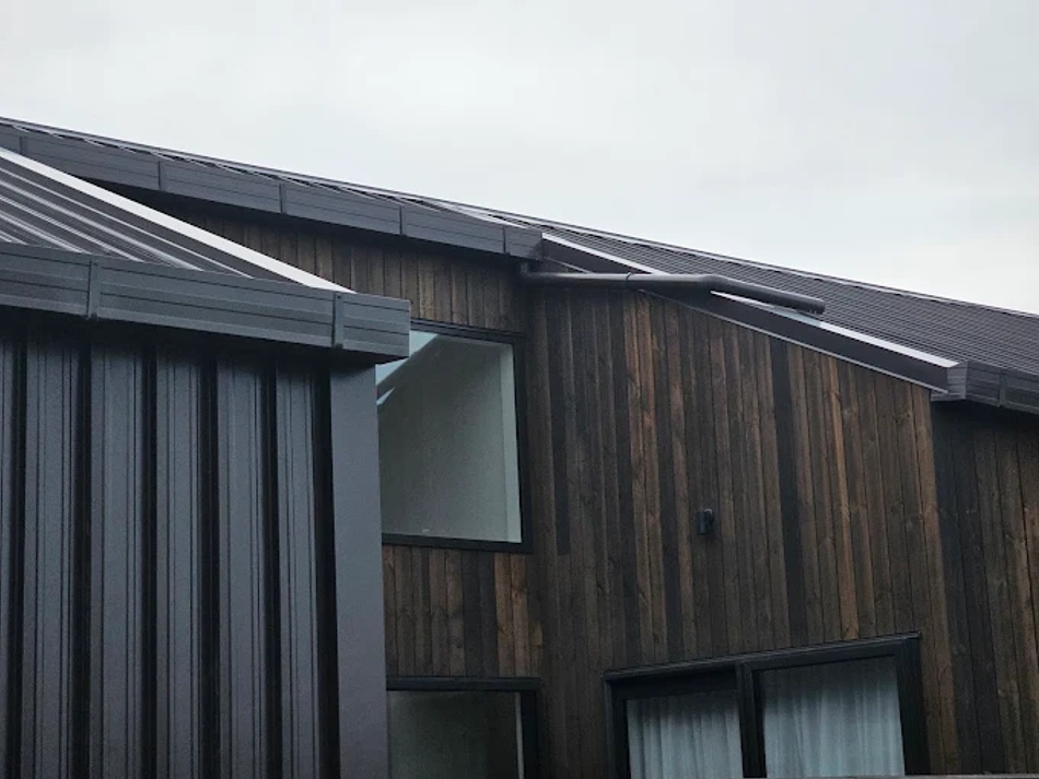 Architectural box gutter installation finished to complement this modern timber-clad home.