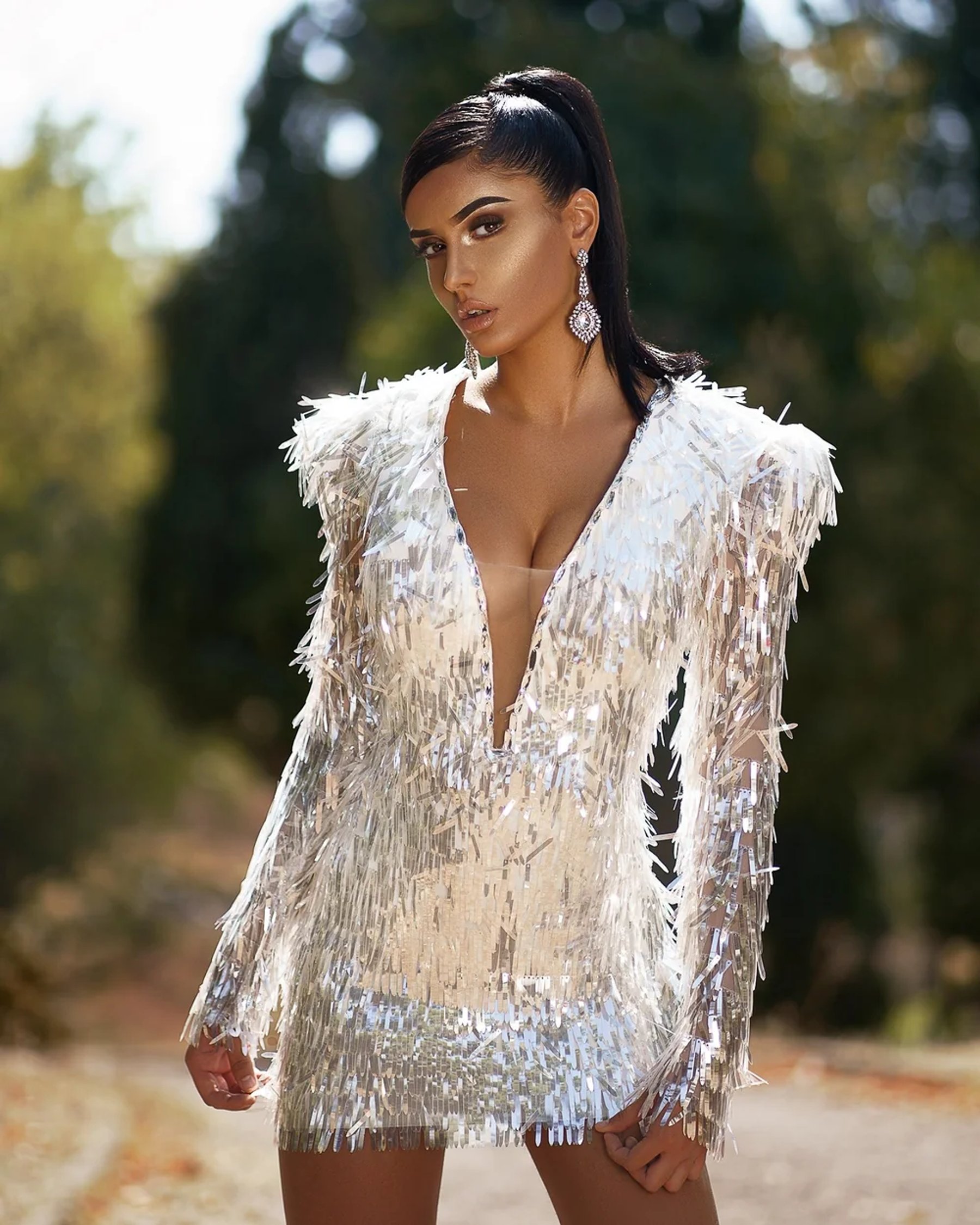 Fashion portrait in a reflective silver dress outdoors — photograph by Ergys Shehu.