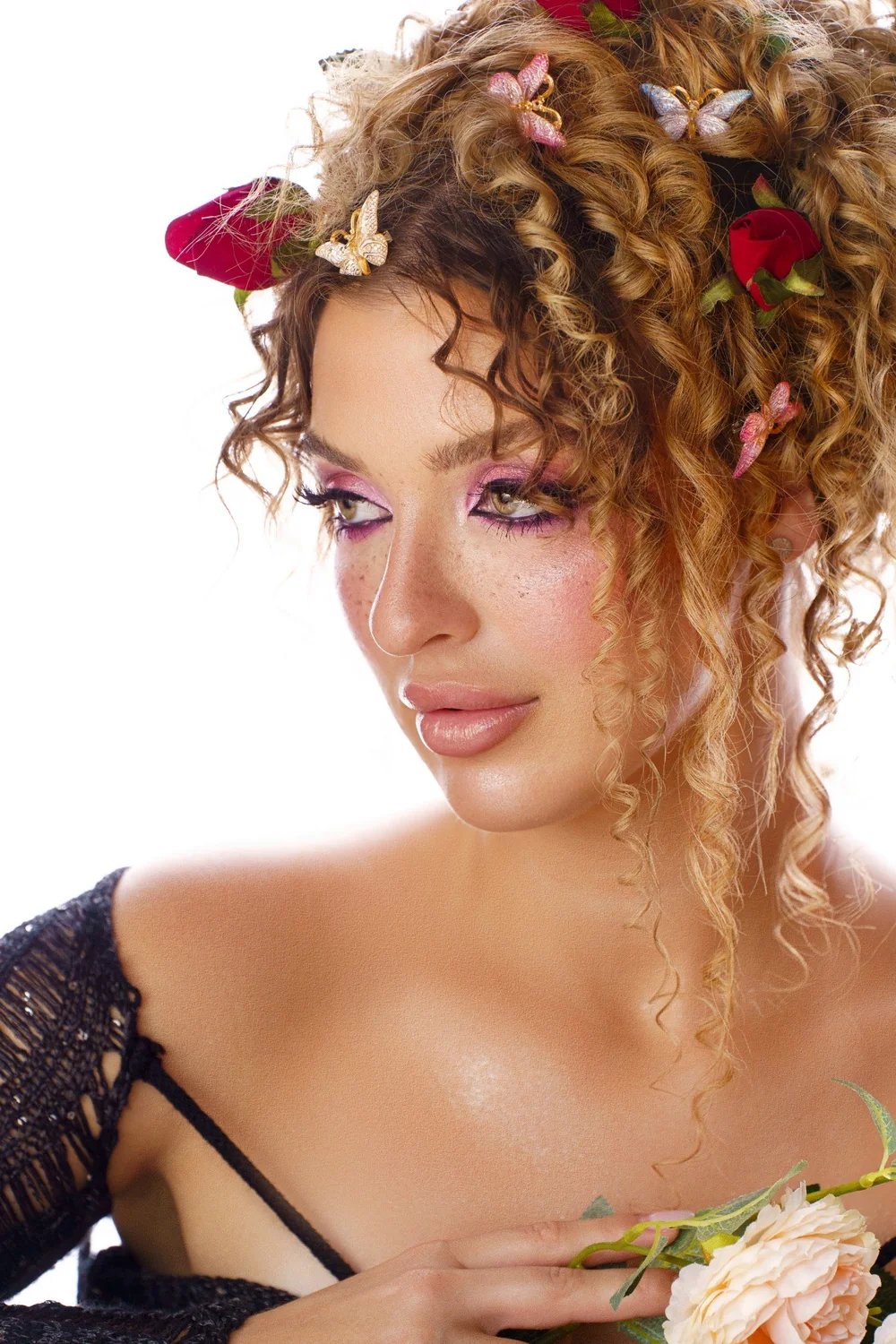 Close beauty portrait with sculptural curls and floral details — photograph by Ergys Shehu.
