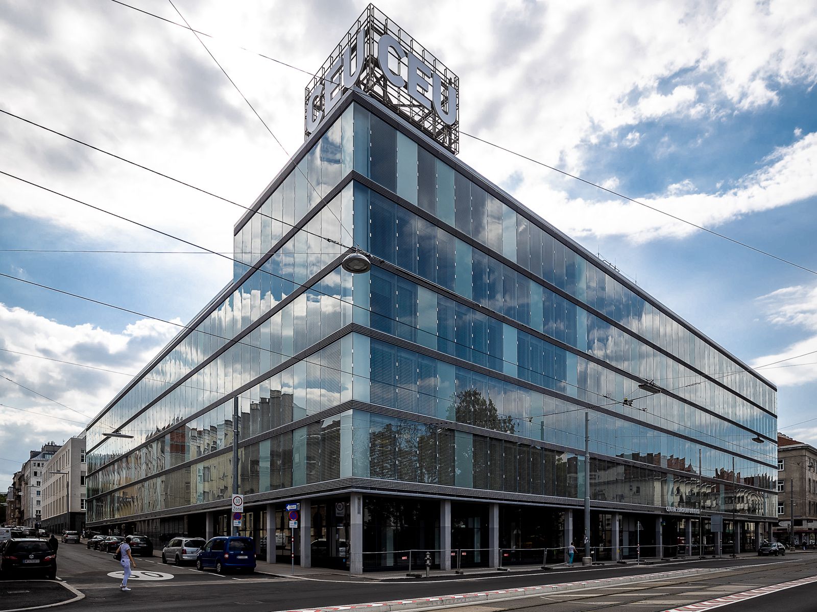 A large glass building with "CEU" in letters on the top.