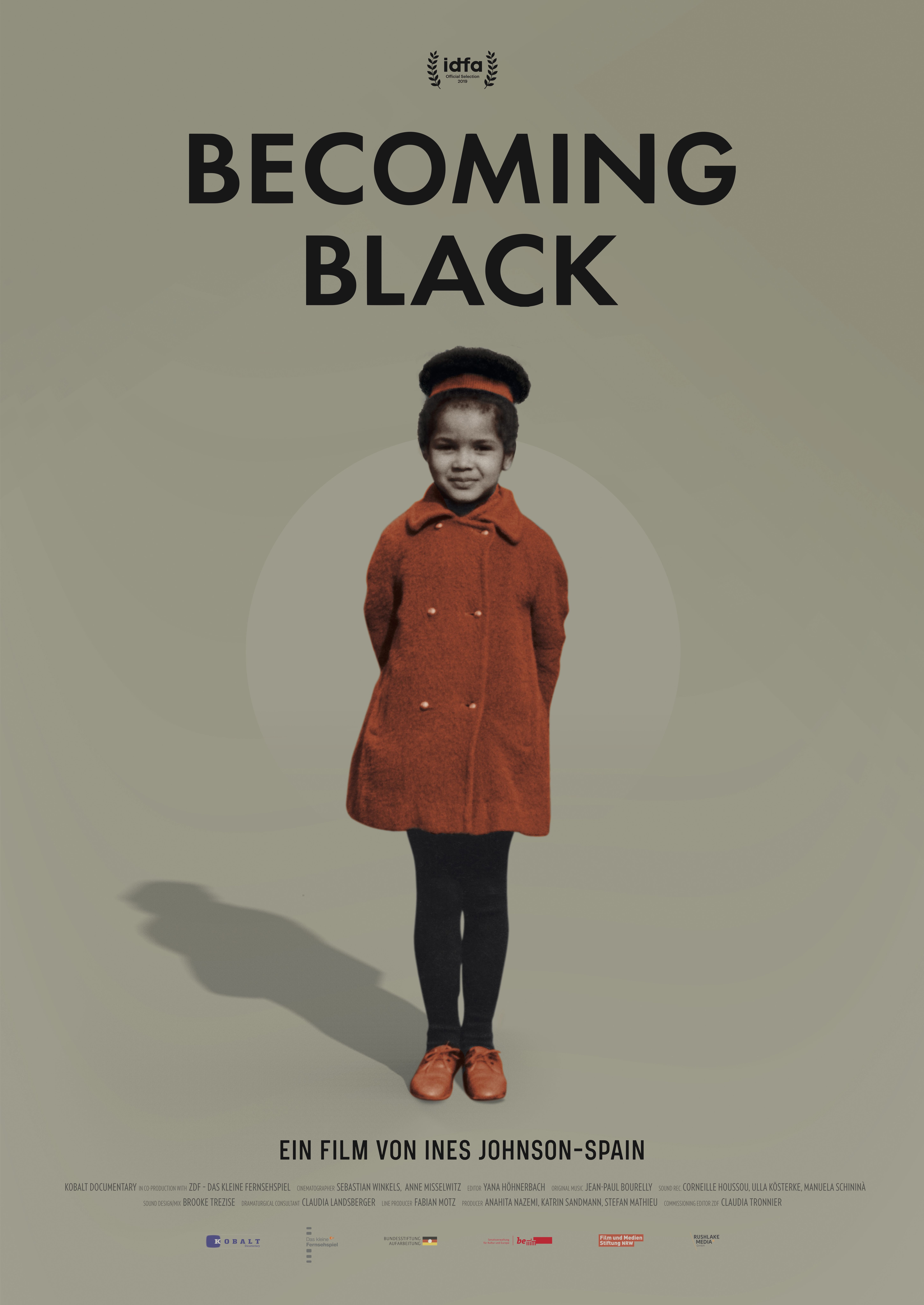 Poster. Text reads: Becoming Black: Ein film von Ines Johnson-Spain. Picture of a young Black girl in an orange-brown coat.