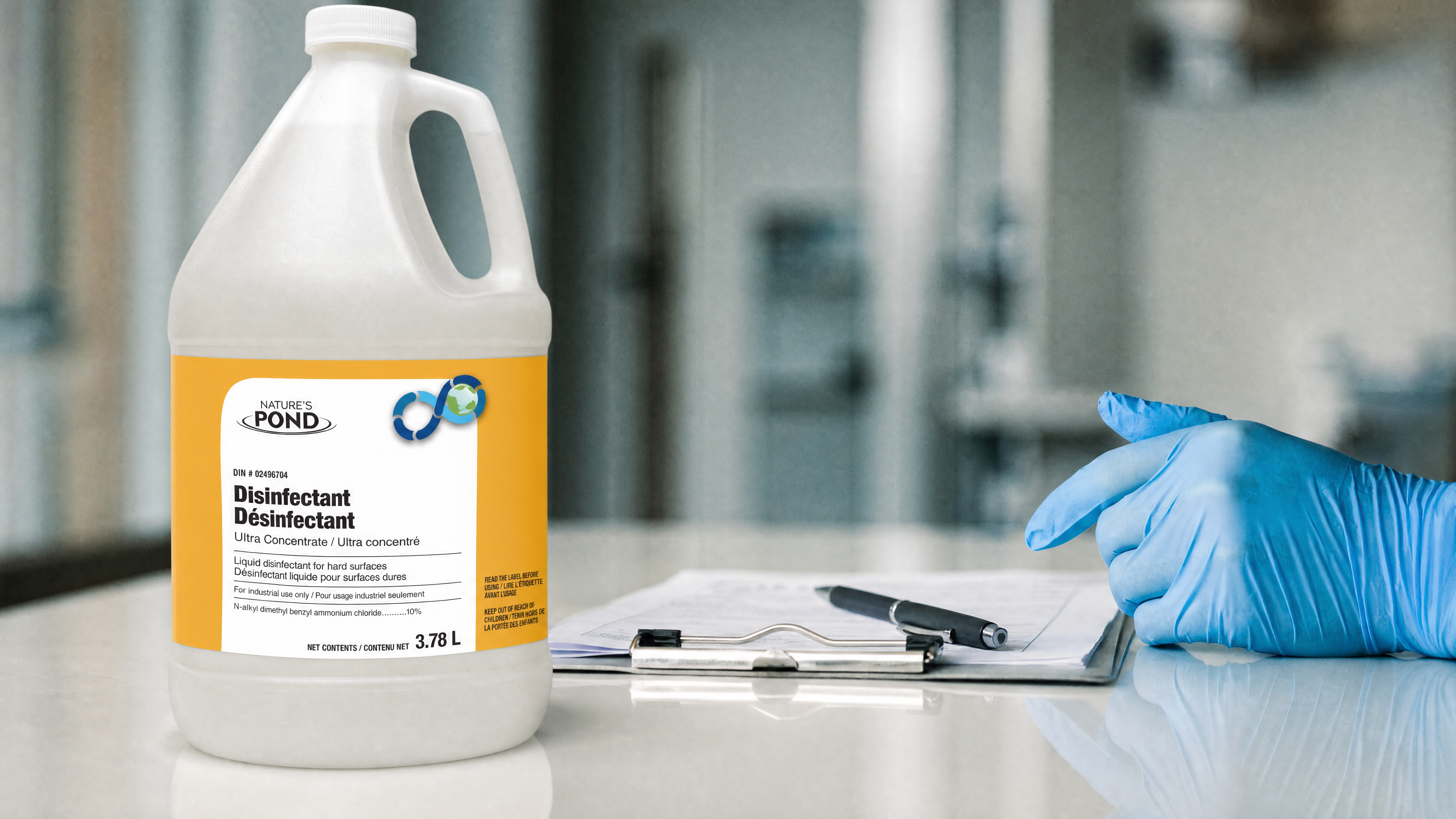 A disinfectant spray bottle beside a clipboard and pen on a clean clinical countertop, a gloved hand nearby.