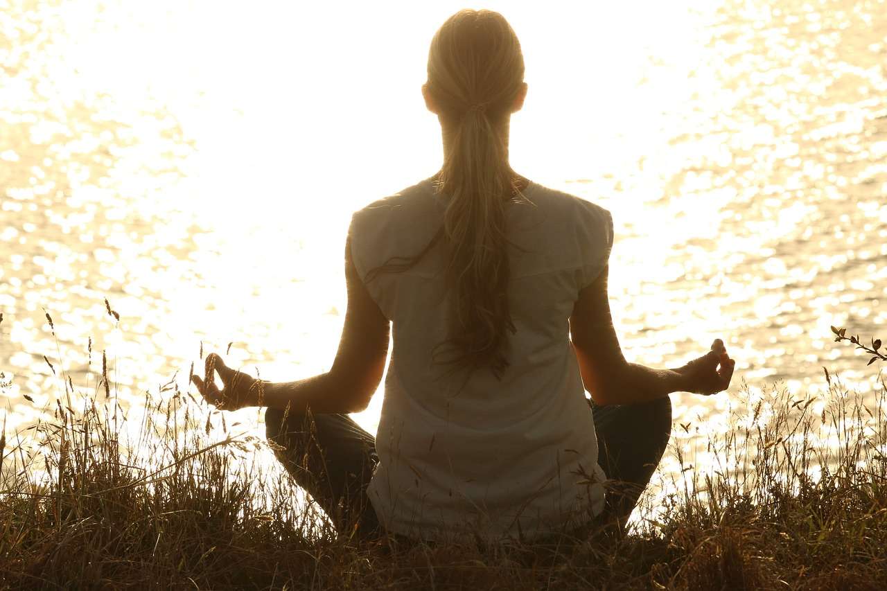 Woman meditating on the shore of Lake Como