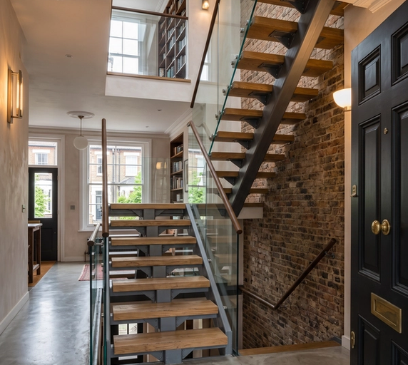 Modern spine staircase with central steel support and timber treads