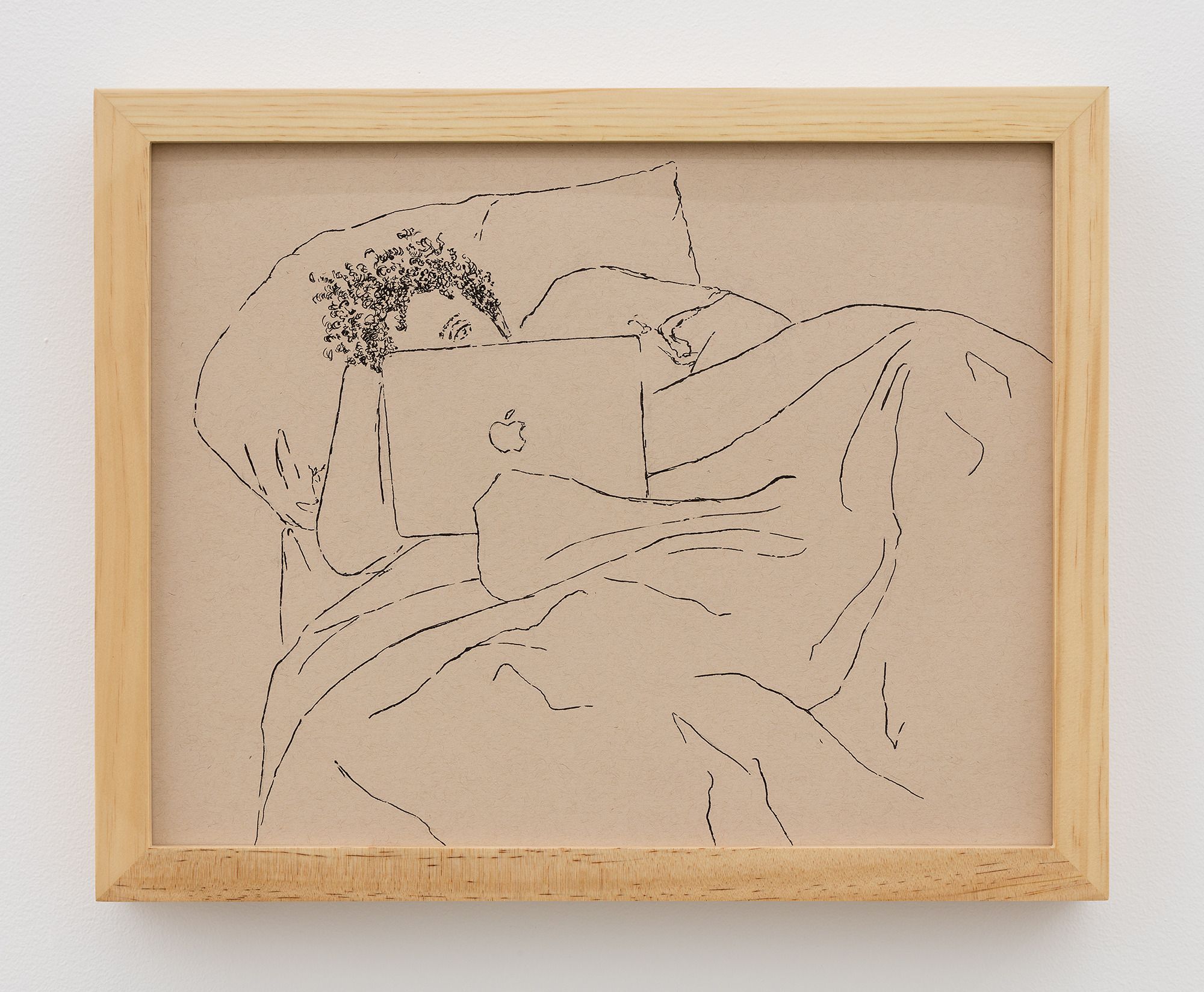 A close-up view of a line drawing in black pen on brown-toned paper in a light wooden frame. The drawing is of a person with tightly coiled curly hair resting in bed while looking at an Apple brand laptop. The figure lays on a pillow with their head propped up by their hand. Their face is mostly obscured by the laptop revealing only one eye. Their body is covered in a blanket. The folds of the blanket take up half of the surface of the drawing.