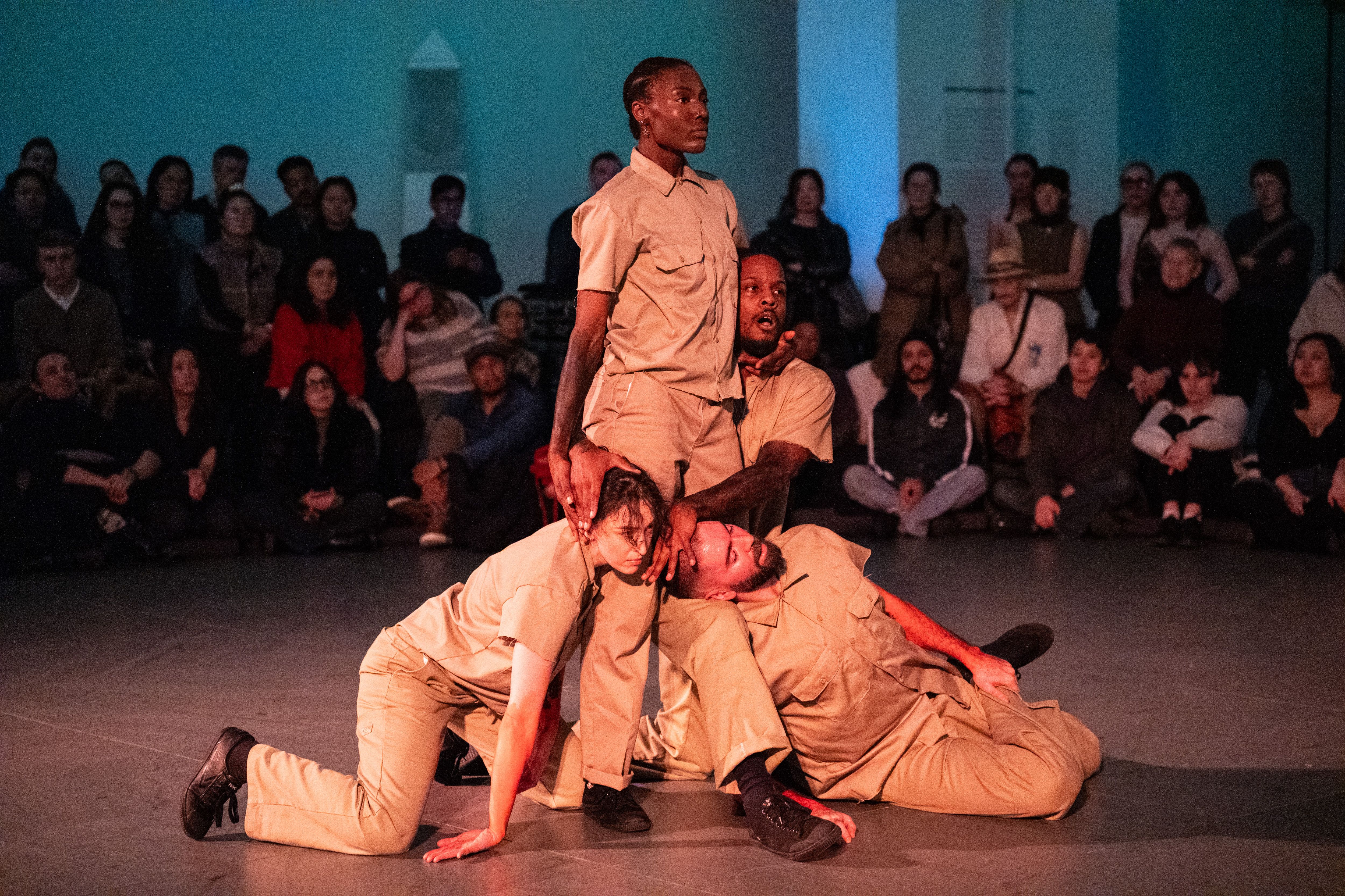 Four people performing in front of an audience