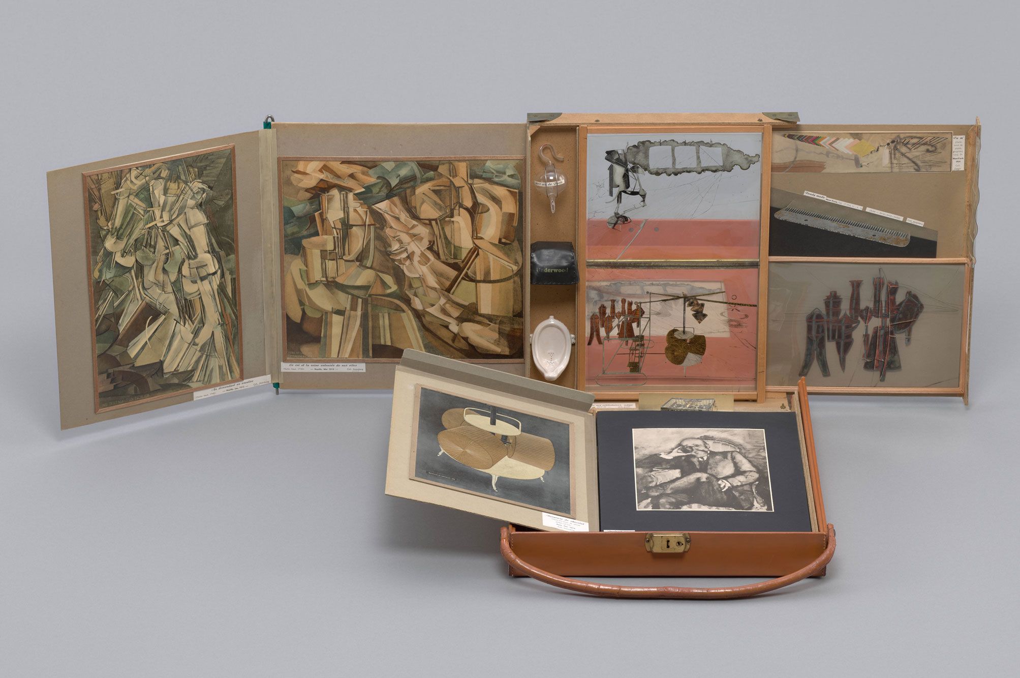 Marcel Duchamp. Box in a Valise (From or by Marcel Duchamp or Rrose Sélavy). 1935–41. Open suitcase displaying a collection of miniature artworks, prints, and objects arranged inside compartments.