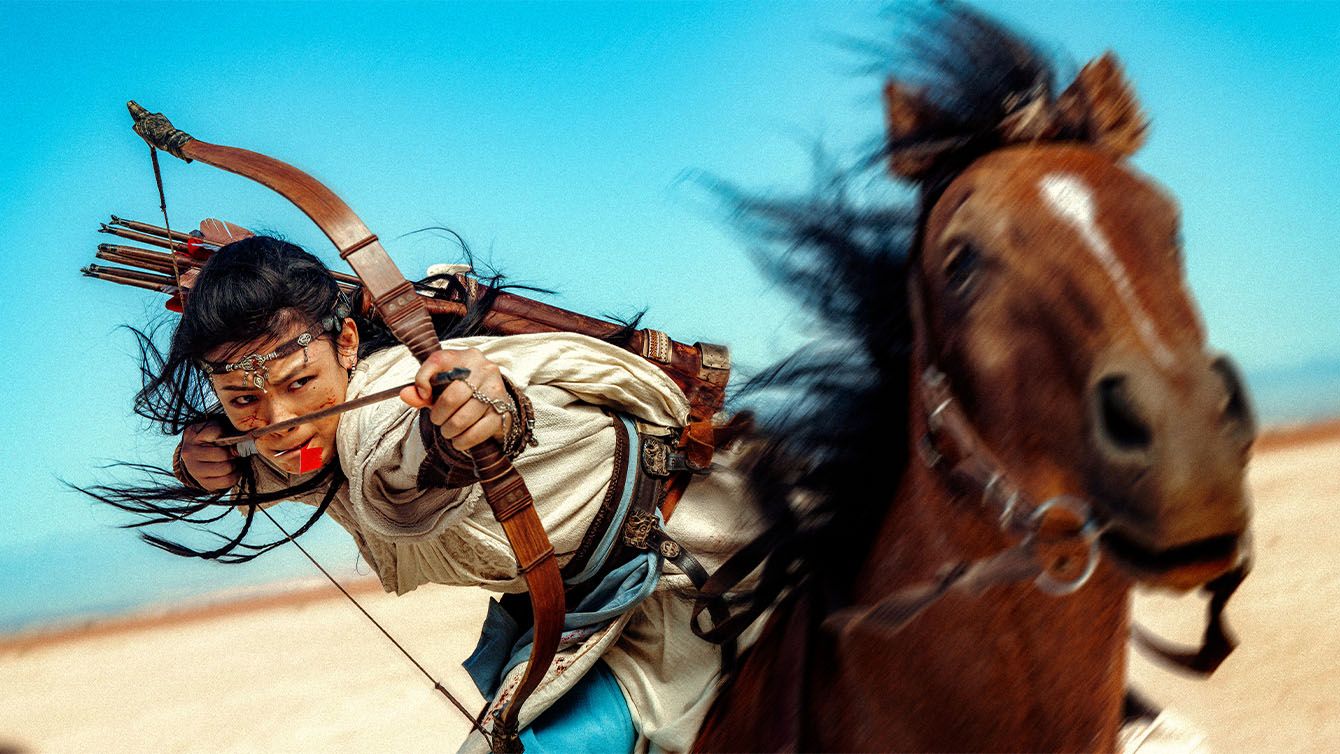A warrior riding a horse and shooting a bow and arrow in movement