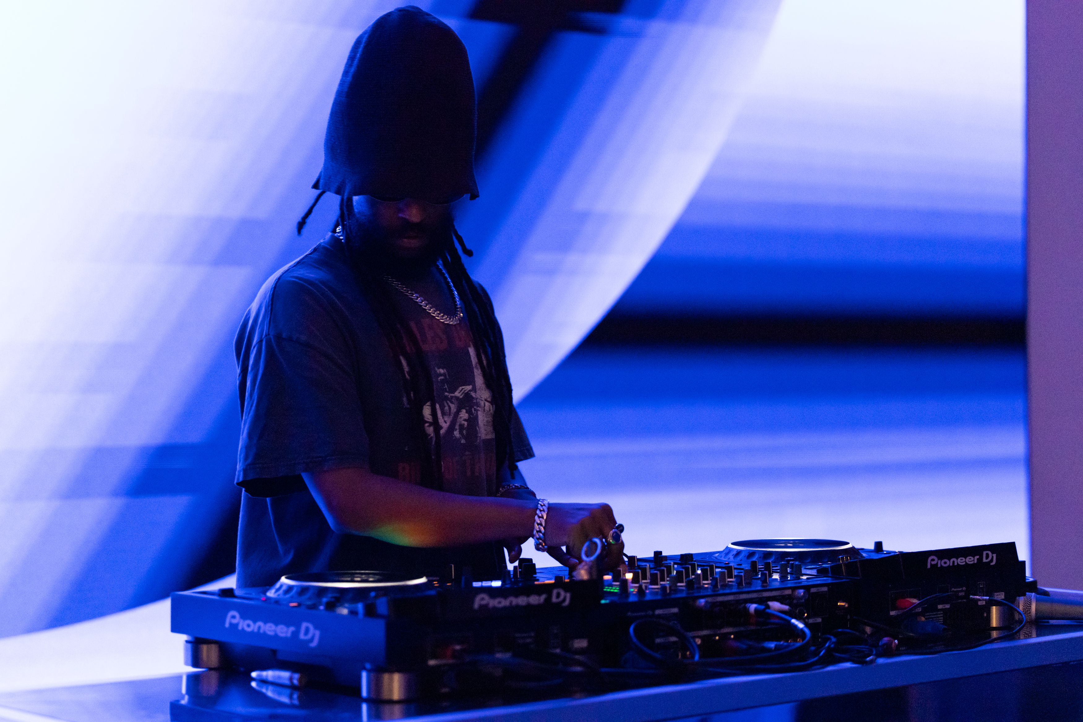 DJ playing at a party with low lights